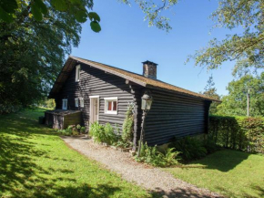 Open wooden chalet built against a hill